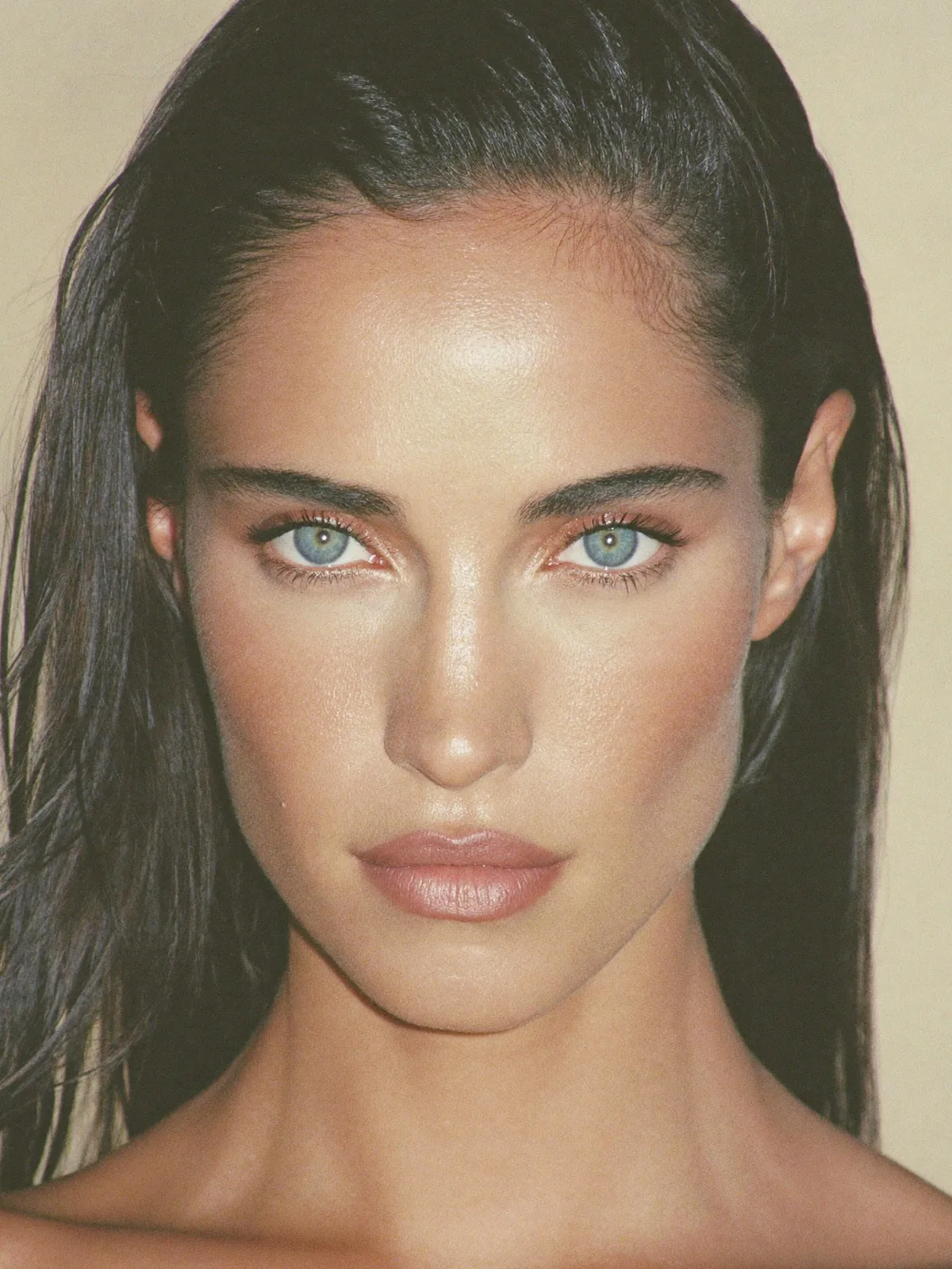 A woman facing the camera, her forehead and brow smooth and unlined